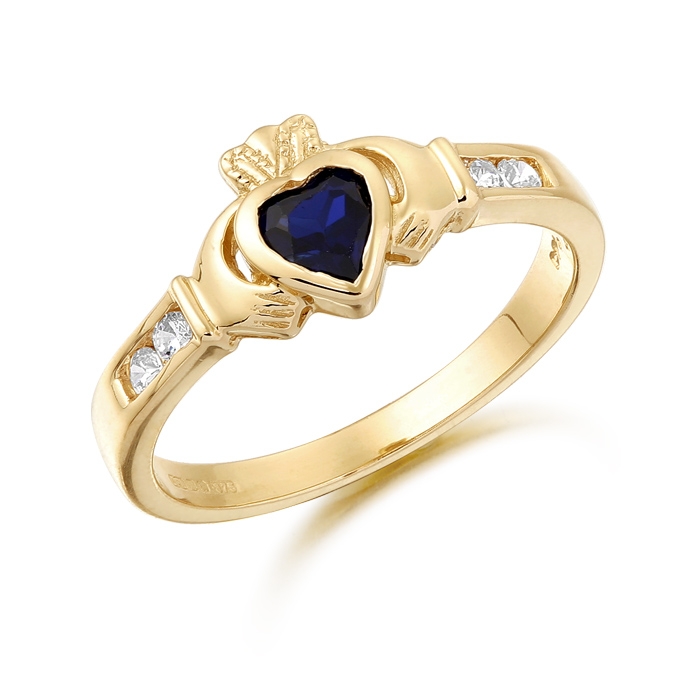 9ct Gold Claddagh Ring studded with Sapphire and precision set Cubic Zirconia settings on each side of the shoulder - CL100S